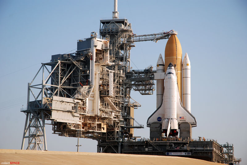 Atlantis and astronauts at the pad